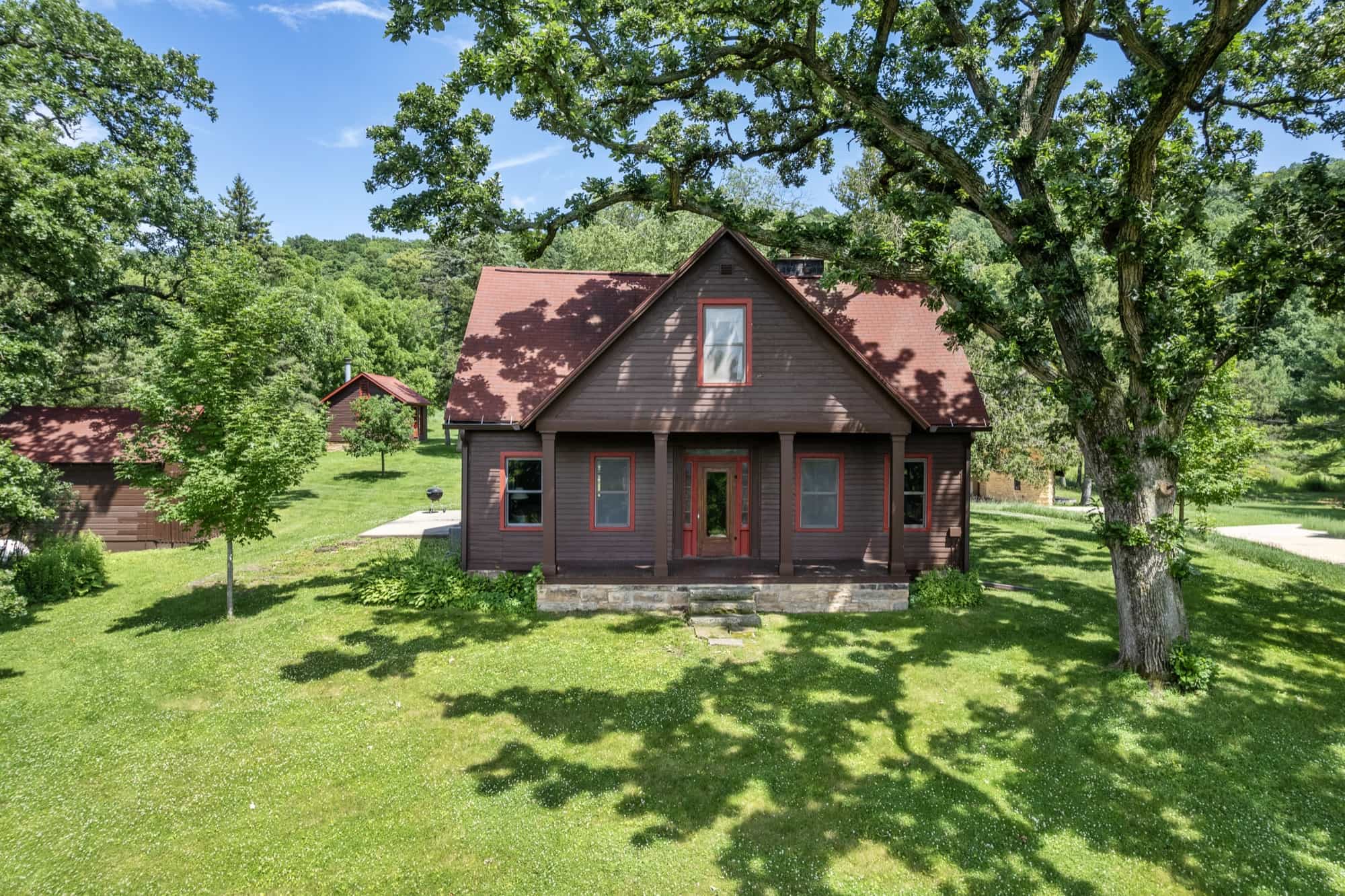 The main house at Aldebaran Farm, framed by oak trees